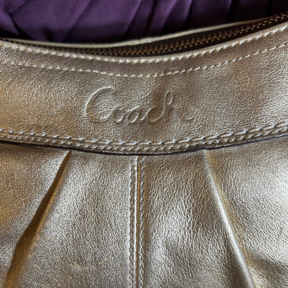 Metallic gold Coach hobo shoulder bag.